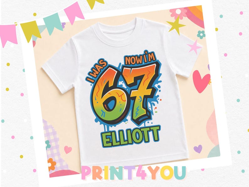 A white t-shirt with a colorful graphic design that says "I WAS NOW I'M 67 ELLIOTT" printed on it.