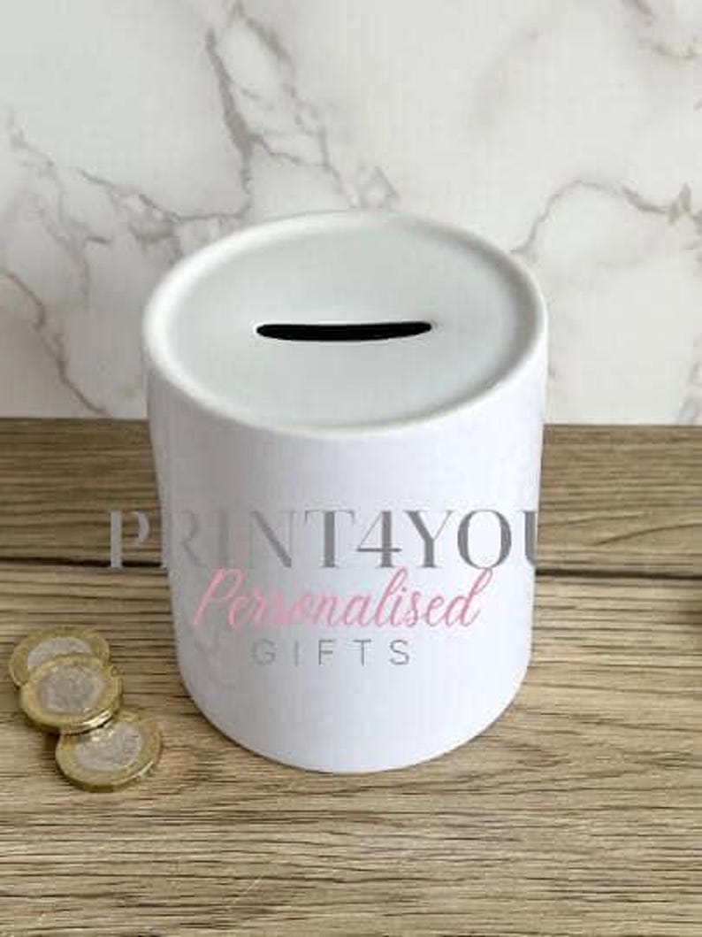 a white trash can sitting on top of a wooden table