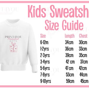 a white sweatshirt with a pink design on it