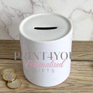 a white trash can sitting on top of a wooden table