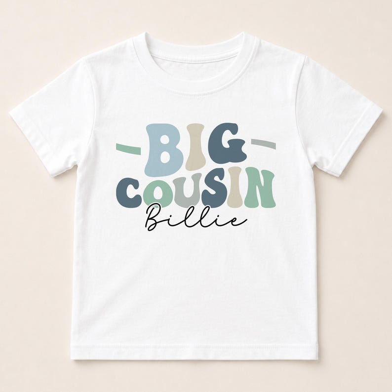 A white t-shirt with the text "BIG COUSIN Billie" printed on it.