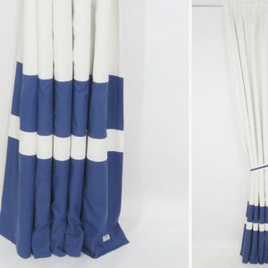 May include: White and blue striped curtains with a simple design. The curtains are made of a soft, woven fabric and have a subtle sheen.