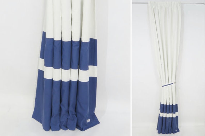 May include: White and blue striped curtains with a simple design. The curtains are made of a soft, woven fabric and have a subtle sheen.