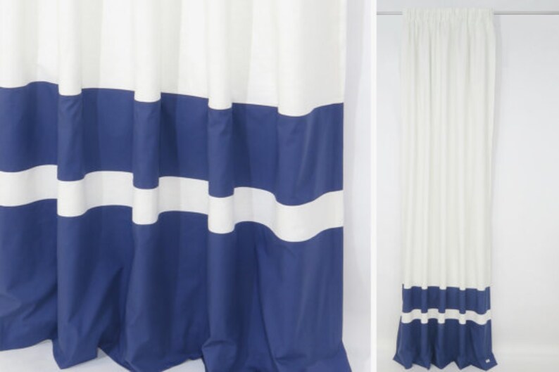 May include: White shower curtain with blue horizontal stripes. The curtain has a simple design with alternating white and blue stripes.