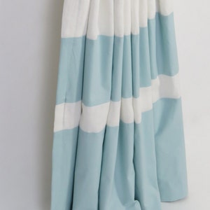 May include: A pair of blue and white striped curtains with a gathered look. The curtains are made of a soft, lightweight fabric.