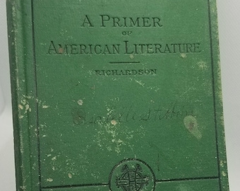 May include: A green book titled "A Primer of American Literature" by Richardson. The book has a worn cover and a small emblem on the bottom.