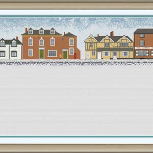 May include: A cross-stitch pattern of a quaint town with a variety of buildings, including a church, shops, and houses. The buildings are all in different colors and styles, and there are trees and bushes in the background.