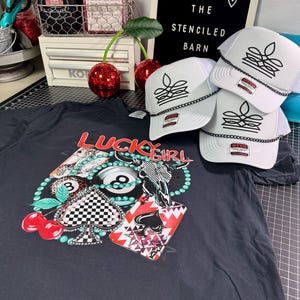 Western cowgirl boot stitch trucker hats displayed with colorful cowgirl graphic apparel