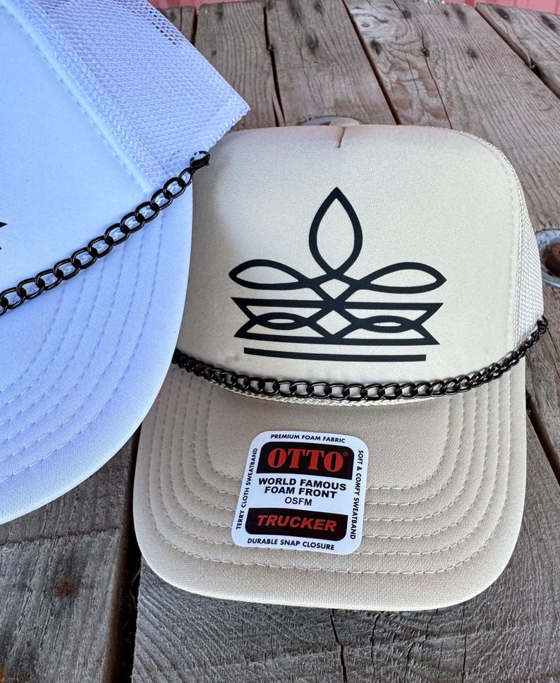Tan cowgirl mesh trucker hat with black boot stitch graphic and chain