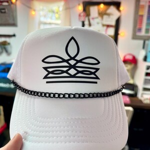 White cowgirl foam trucker hat with black western boot stitch design and chain