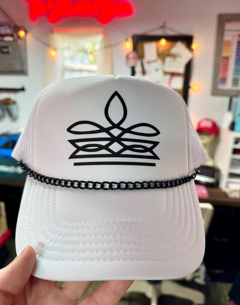 White cowgirl foam trucker hat with black western boot stitch design and chain