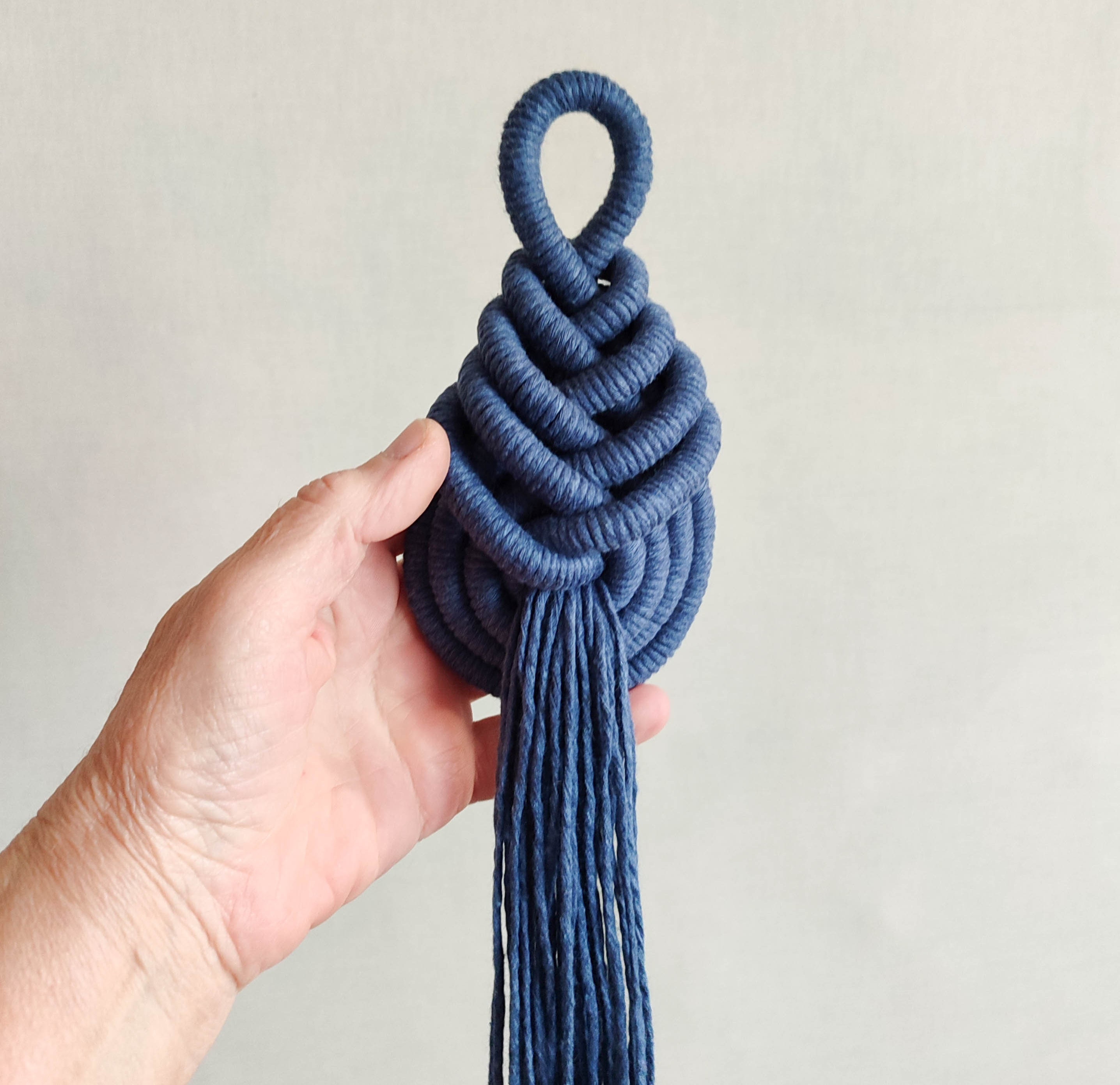 Large macrame pipa knot tassel, decorative fringe wall hanging object, modern minimalist soft textile sculpture, fibre art, home decoration