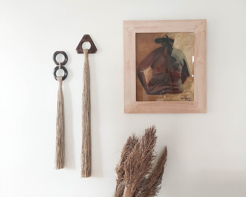 Decorative wall hanging set of two, made of wood and hemp twine. Comes in two different shapes: triangle and double circle.