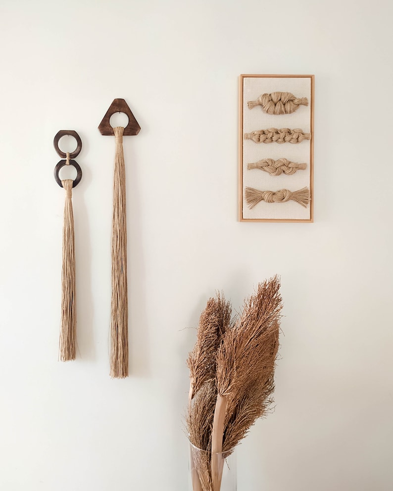 Decorative wall hanging set of two, made of wood and hemp twine. Comes in two different shapes: triangle and double circle.