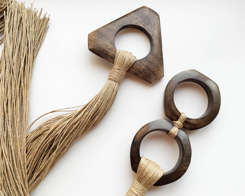 Decorative wall hanging set of two, made of wood and hemp twine. Comes in two different shapes: triangle and double circle.