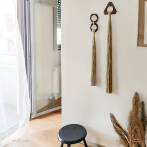 Decorative wall hanging set of two, made of wood and hemp twine. Comes in two different shapes: triangle and double circle.
