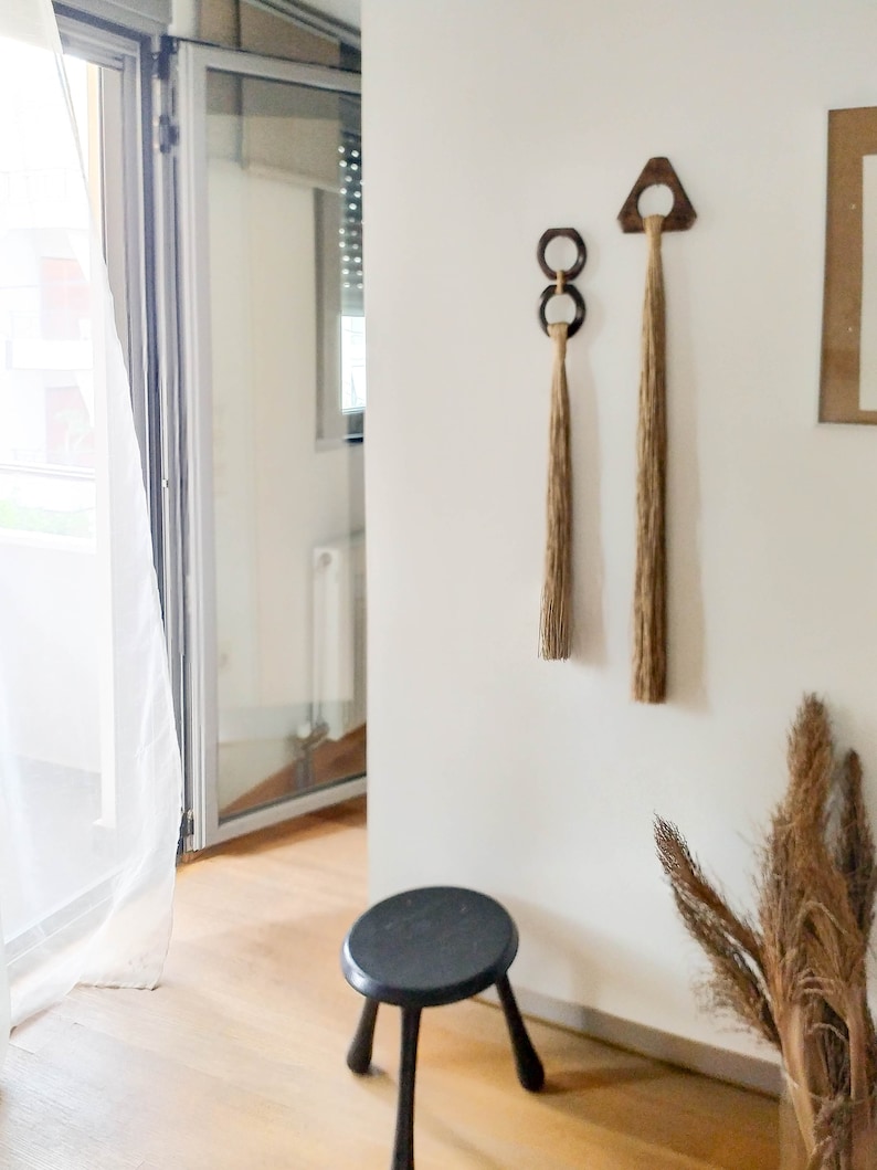 Decorative wall hanging set of two, made of wood and hemp twine. Comes in two different shapes: triangle and double circle.