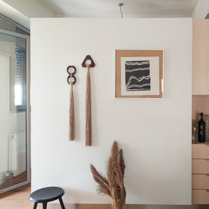 Decorative wall hanging set of two, made of wood and hemp twine. Comes in two different shapes: triangle and double circle.