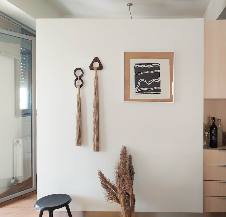 Decorative wall hanging set of two, made of wood and hemp twine. Comes in two different shapes: triangle and double circle.