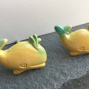 May include: Two yellow whale-shaped drawer pulls with green accents.