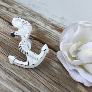 May include: White painted metal anchor with rope detail. Nautical themed cabinet knob or drawer pull.