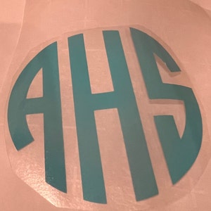 May include: Teal blue vinyl monogram sticker with the letters AHS in a circle.