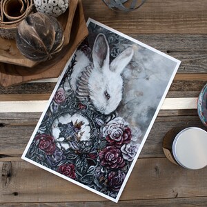 May include: A white rabbit with red eyes is surrounded by dark red roses and a clock face with a butterfly. The background is a soft gray with a watercolor effect.