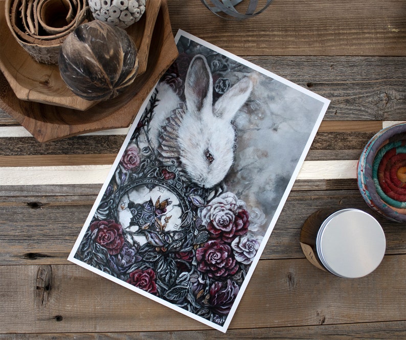 May include: A white rabbit with red eyes is surrounded by dark red roses and a clock face with a butterfly. The background is a soft gray with a watercolor effect.