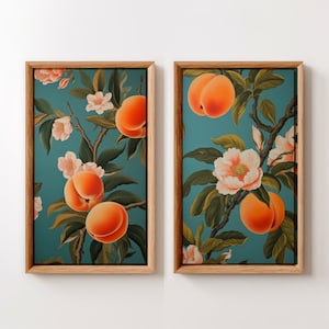 May include: Two framed prints with a teal background featuring peach fruit and white flowers. The prints are in wooden frames.