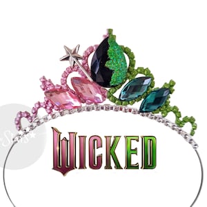 May include: A decorative tiara with pink, teal, and black gemstones. The tiara has a silver band and a star-shaped detail. The word "WICKED" is displayed in a decorative font below the tiara.