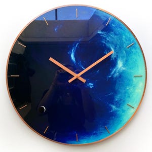 Eye-catching Neptune clock designed for celestial enthusiasts. This oversized wall clock glows in the dark, making it a beautiful addition to your decor while celebrating the Pisces sign stylishly. Large wall clock. Huge wall clock. Big wall clock.