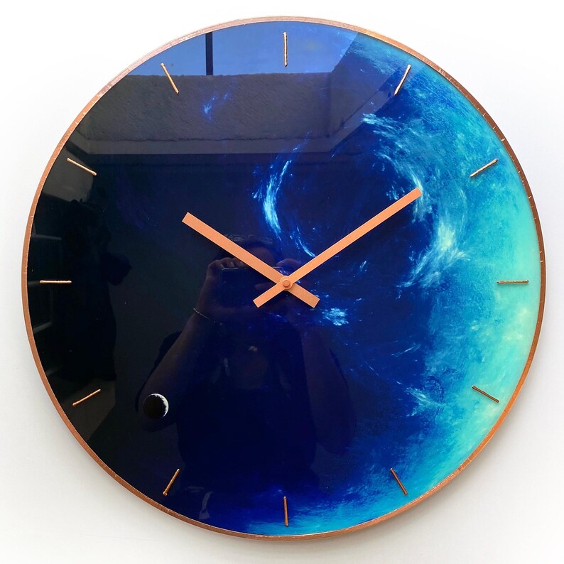 Eye-catching Neptune clock designed for celestial enthusiasts. This oversized wall clock glows in the dark, making it a beautiful addition to your decor while celebrating the Pisces sign stylishly. Large wall clock. Huge wall clock. Big wall clock.