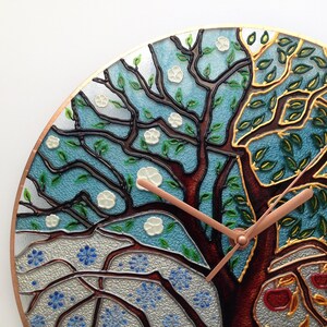 Handcrafted 24-inch stained glass wall clock with a four-season tree design. The oversized format makes it perfect for modern interiors, adding a unique touch to living rooms, family rooms, or dining areas.