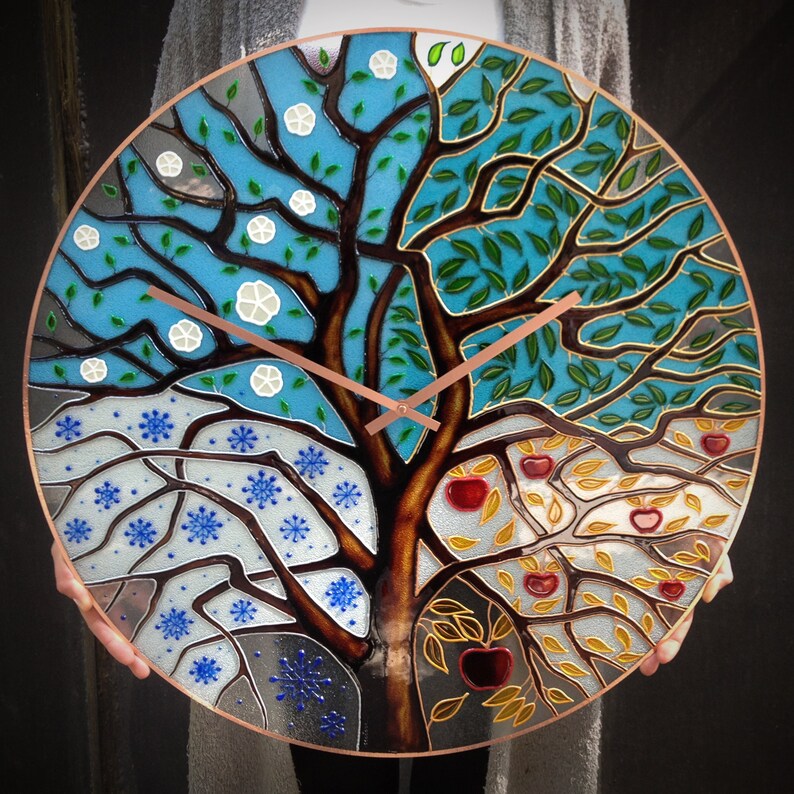 Stunning 24" stained glass clock with a four-season tree design. Perfect for those who love unique, oversized clocks that also serve as contemporary wall art. A stylish addition to your living room, dining area, or office decor.