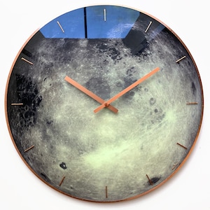 Astronomy-themed Moon wall clock, glowing softly in the dark. Perfect for yoga or hotel decor, its lunar design creates a celestial ambiance. Ideal as a zodiac gift for Cancer or as a unique addition to any minimalist space.