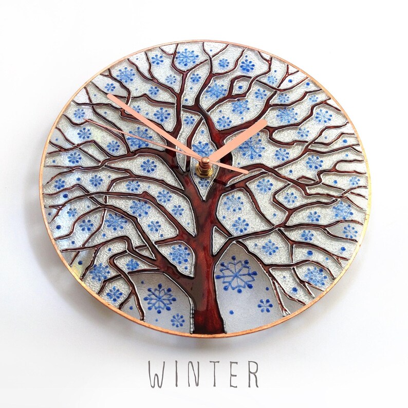 Winter Tree of Life wall clock with snowy branches, handcrafted glass artwork inspired by nature and changing seasons