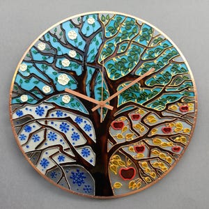 Close view of handcrafted Tree of Life wall clock, hand painted on glass with seasonal branches and detailed artistic texture