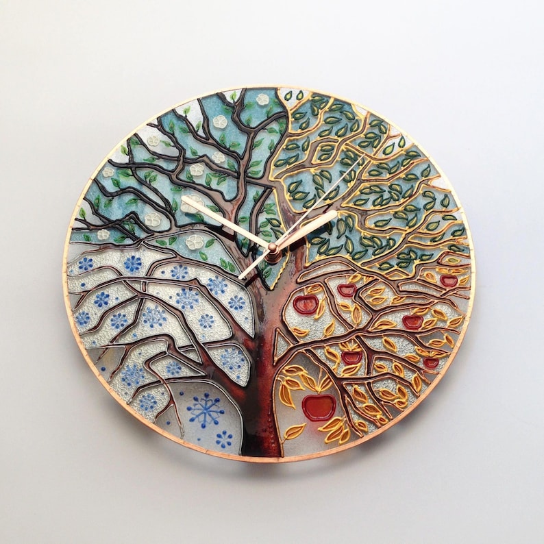 24" glass clock with a hand-painted four-season tree design. Oversized and perfect for large walls, this clock doubles as a stunning art piece for your home. Quiet movement makes it suitable for any peaceful environment, like living rooms or offices.