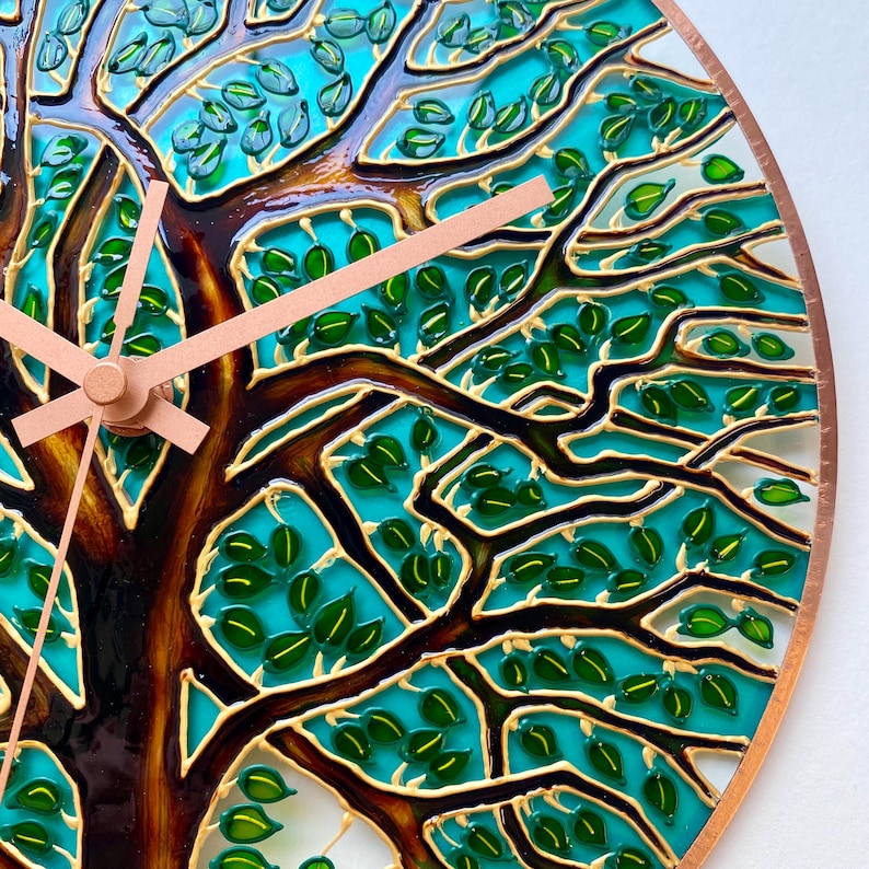 Close up of Tree of Life glass wall clock, detailed hand painted branches and leaves, stained glass inspired nature artwork