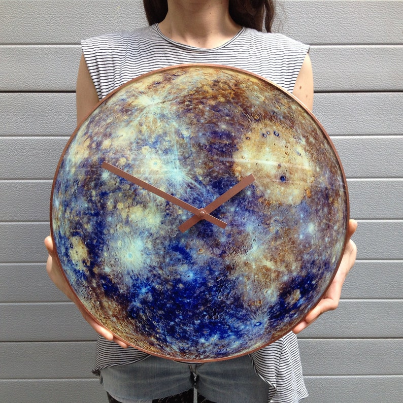 Mercury-inspired glass wall clock, featuring celestial details and a glow-in-the-dark effect. Perfect for astronomy lovers and modern interior decor. Ideal as a zodiac gift for Gemini and Virgo. A magical touch to your office or yoga space.