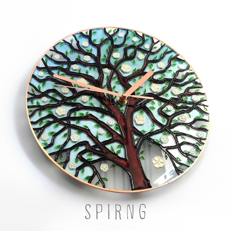 Spring Tree of Life glass wall clock featuring blooming branches and hand painted seasonal details in turquoise and soft colors