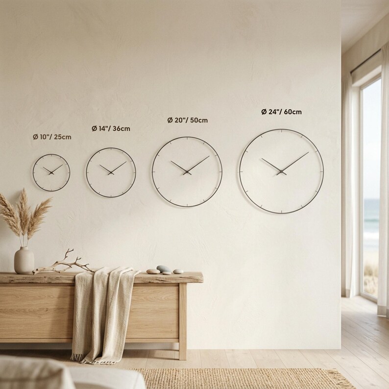 Size comparison chart showing four round wall clocks in a bright neutral interior, labeled 10"/25 cm, 14"/36 cm, 20"/50 cm and 24"/60 cm to help customers compare their scale on a wall.