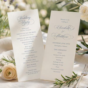 May include: Two cream-colored wedding program cards with dark blue serif and script text. The left card lists the wedding party, while the right card displays the names Elizabeth and Matthew, the date June 28th, and the ceremony order.