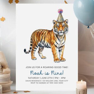 May include: A birthday party invitation featuring a watercolor illustration of a tiger wearing a party hat. The invitation reads "Noah is Nine!" with event details. The tiger is orange and black with a gold party hat.