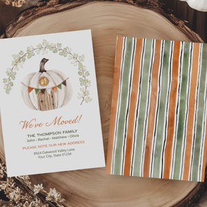 May include: Two rectangular cards featuring a moving announcement. One card displays a white pumpkin illustration with a banner, eucalyptus wreath, and text reading We've Moved, The Thompson Family, and address details. The second card has vertical stripes.