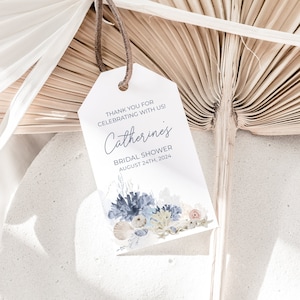 May include: White tag with blue and beige watercolor floral design. The tag says "Thank you for celebrating with us! Catherine's Bridal Shower August 24th, 2024".