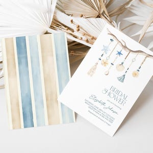 May include: Two cards with a watercolor design. One card has vertical stripes in beige, blue, and light blue. The other card is a bridal shower invitation with a branch and seashell design, with the text "Bridal Shower".