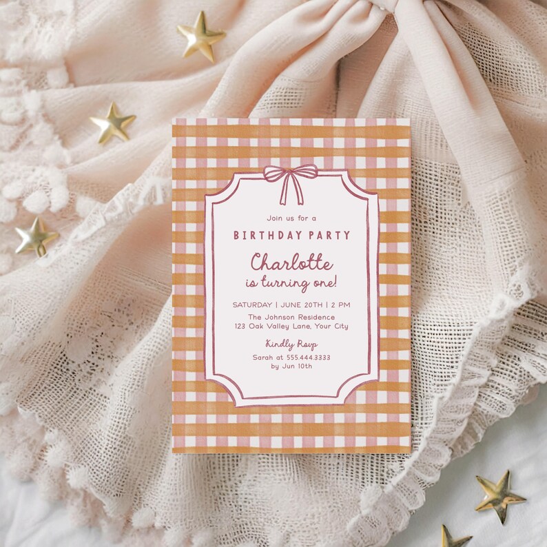 May include: A birthday party invitation with a pink and orange gingham pattern. The invitation reads "Join us for a Birthday Party, Charlotte is turning one!" with event details. The invitation is on a textured, light pink surface with gold star decorations.