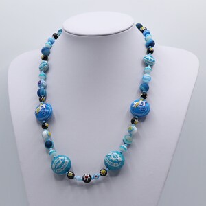 Bottle cap necklace in turquoise blue, black and white.  Retro American recycled bottle tops. Lizards. Millefiore glass beads
