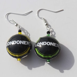 Recycled LONDONER bottle cap earrings.  One black yellow, one black green. Upcycled beer bottle caps made into rounded beads.